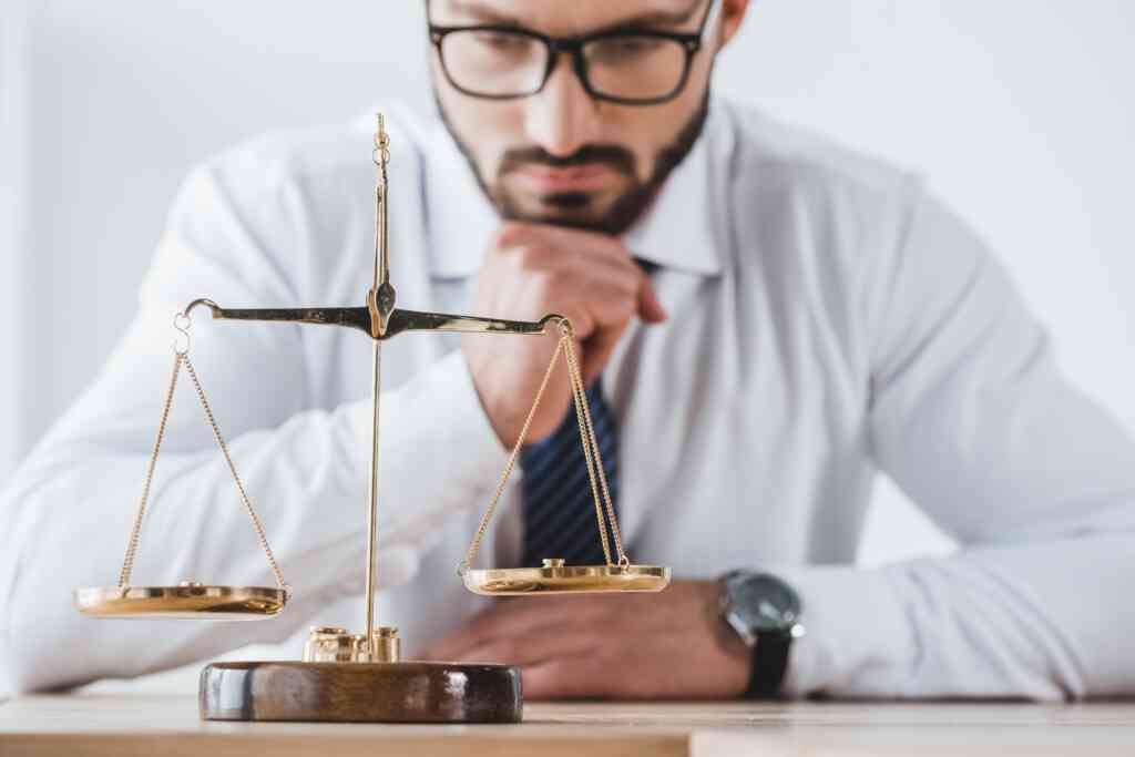 A man looking at the balance in scales