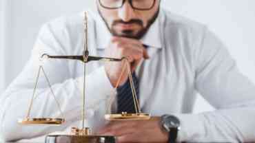 A man looking at the balance in scales