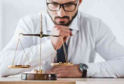 A man looking at the balance in scales