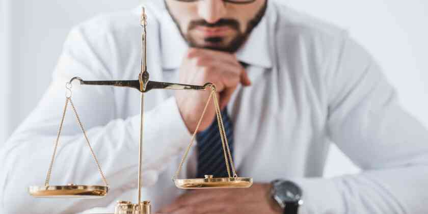 A man looking at the balance in scales